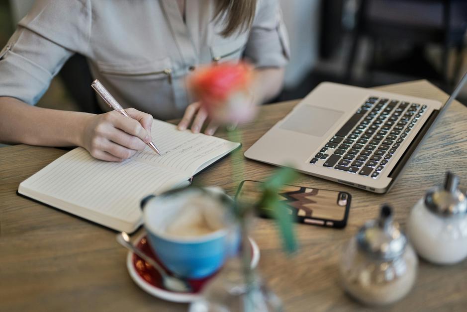 A person reviews diverse digital content on a laptop, focused and engaged in their work.